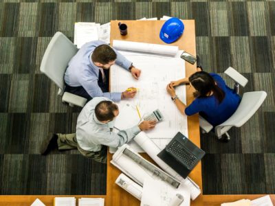 Overview of three people at a desk working