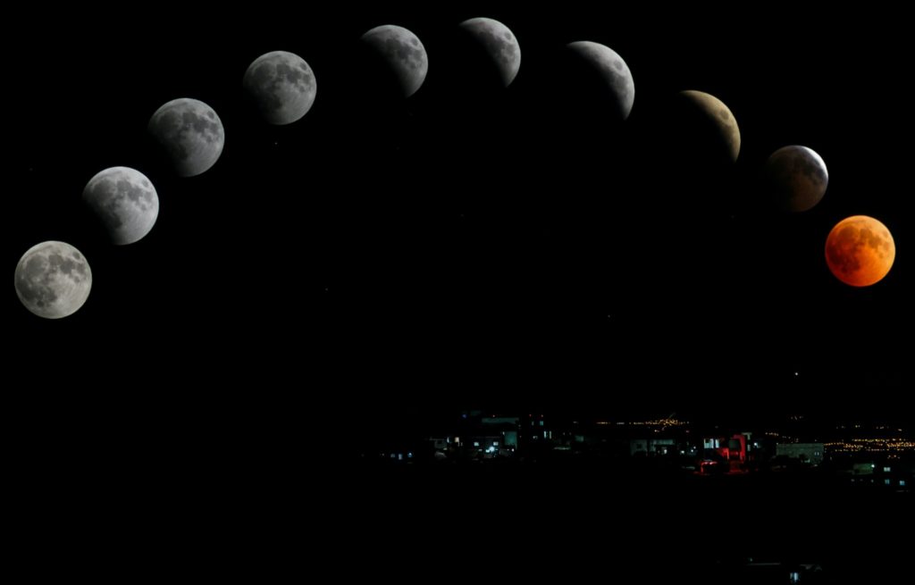 Different moons floating next to each other, each a different moonphase.