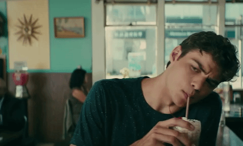 Peter kavinsky sipping a drink