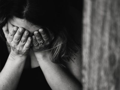 woman anxious with head in hands