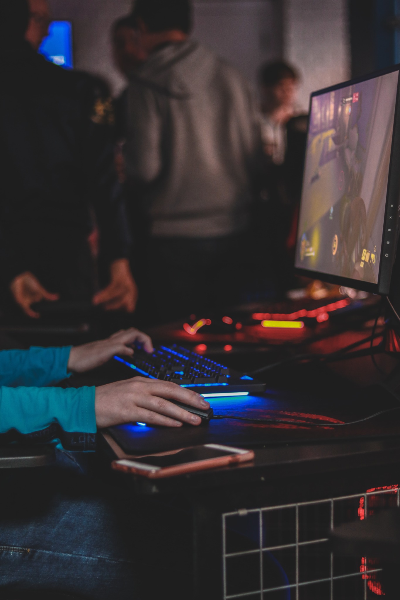 Two hands on a mouse and keyboard.