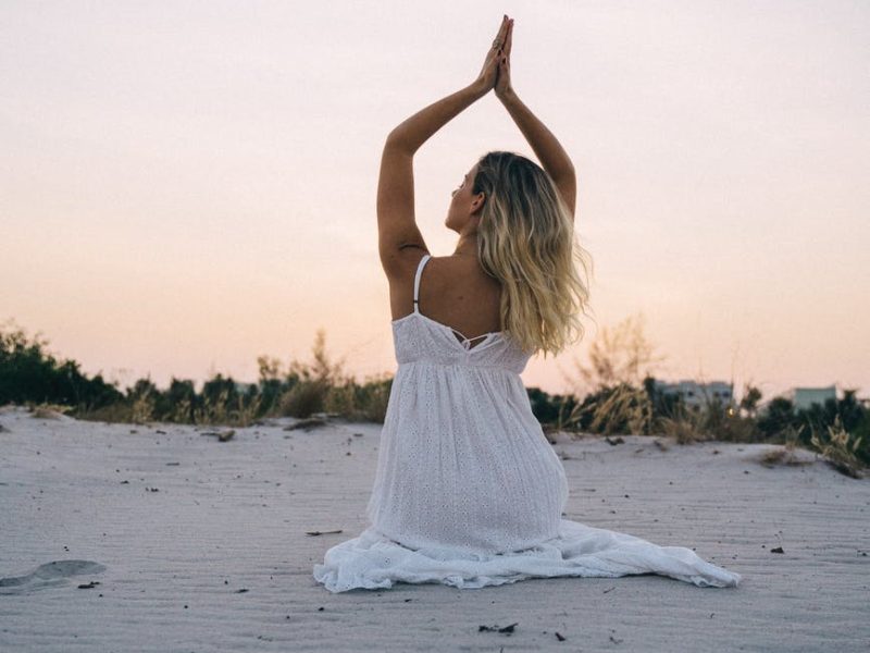 Woman meditating on beach