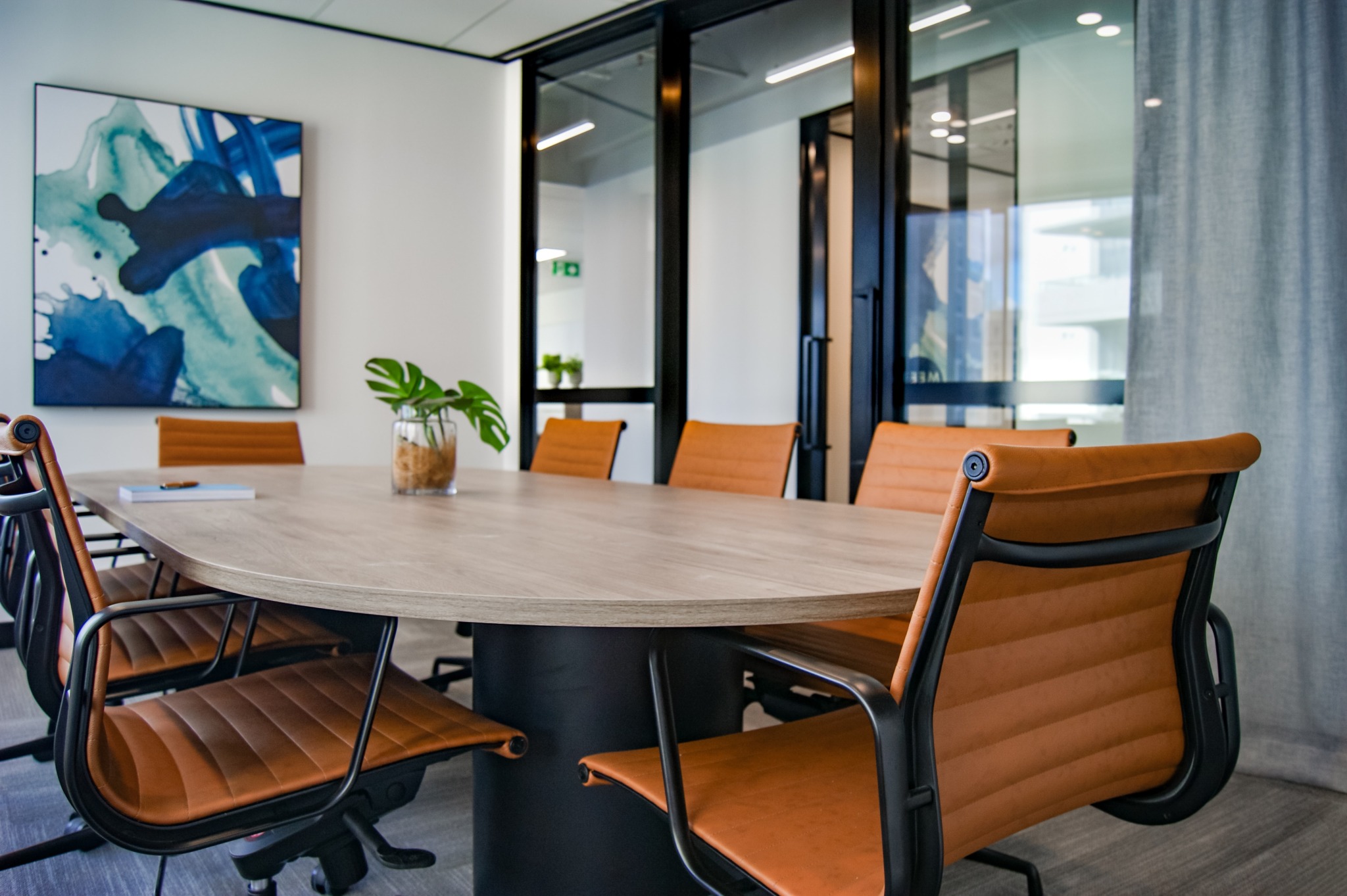 Brown wooden 9-piece office table and chairs.