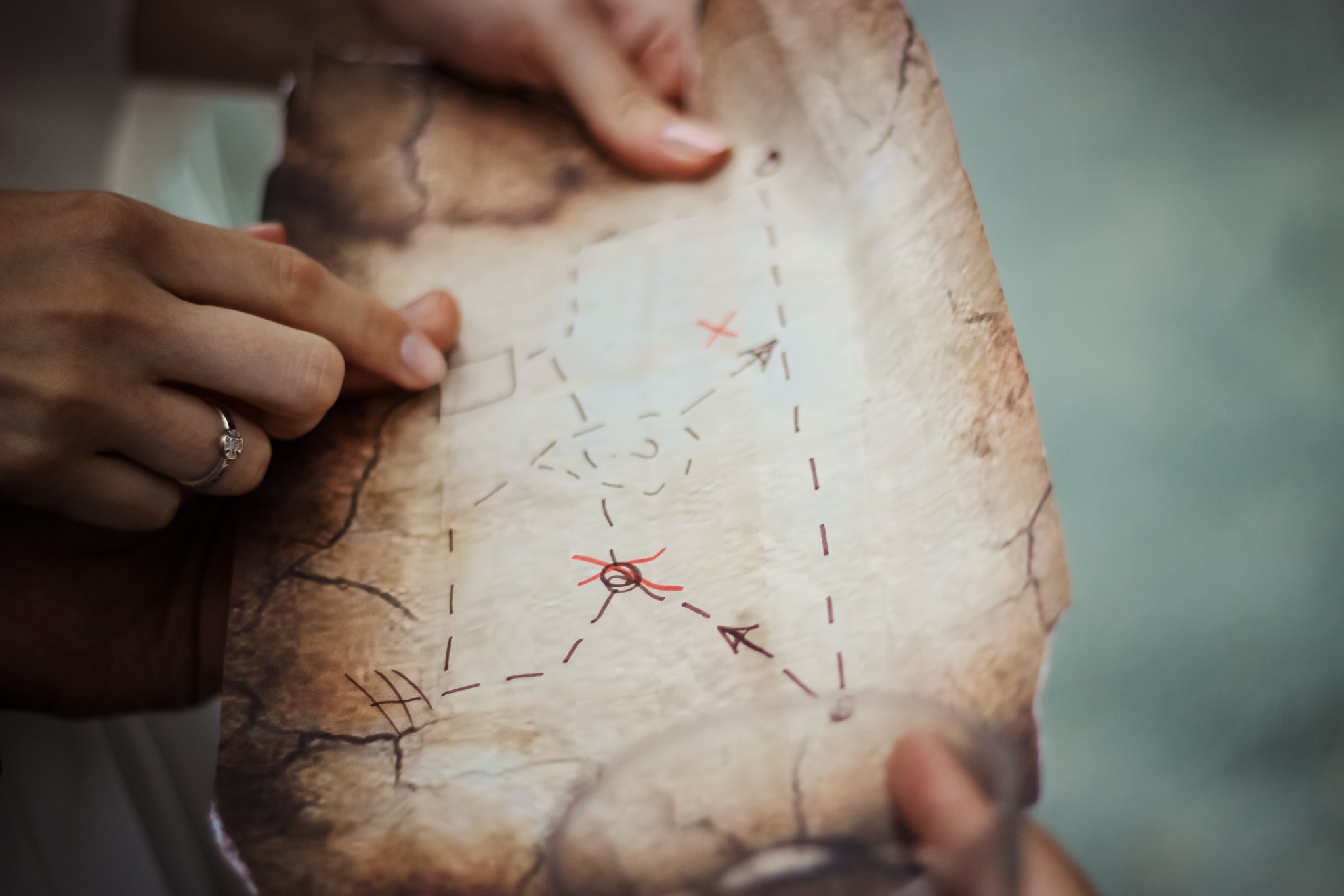 Person holding brown map.