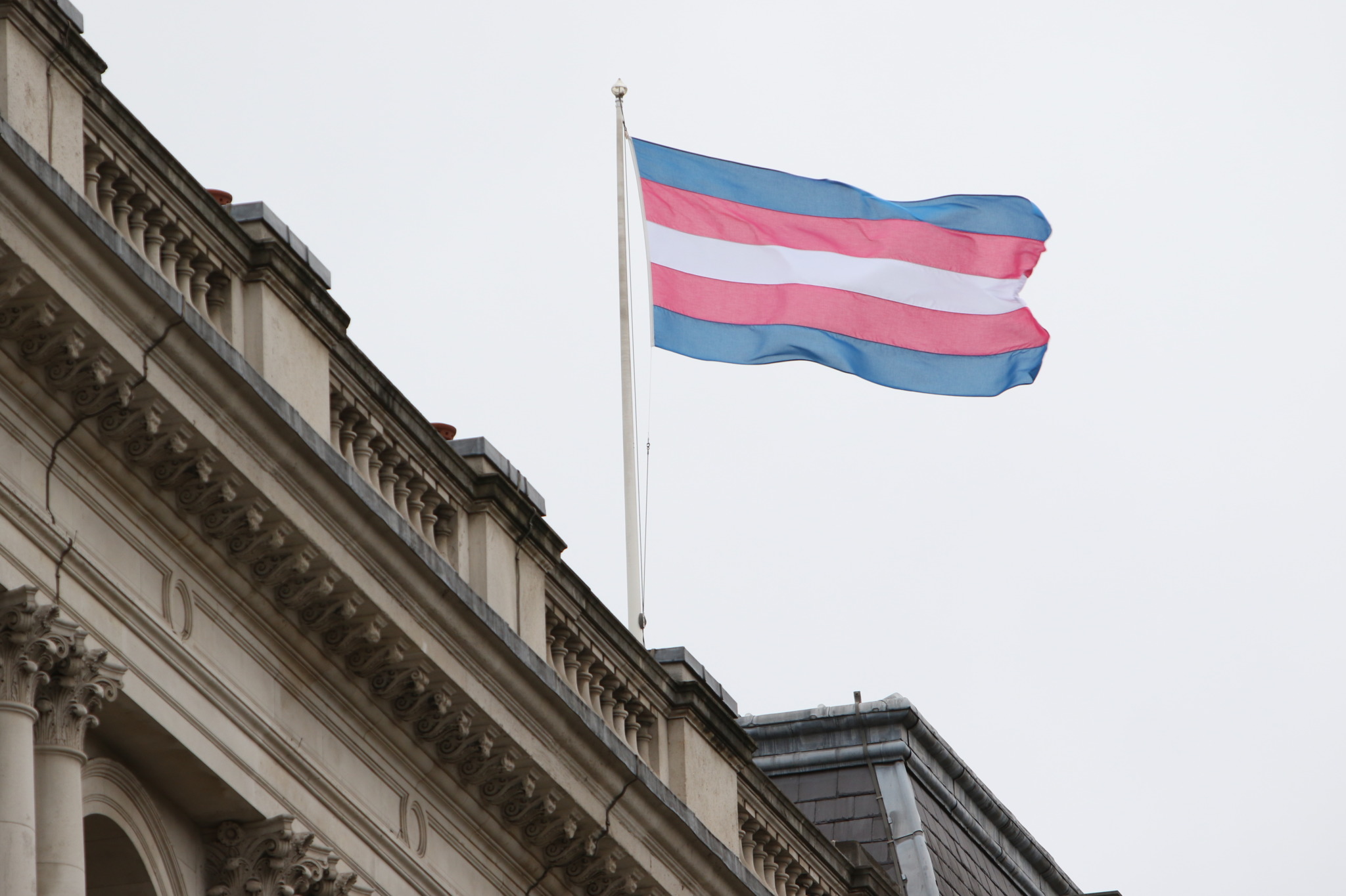 Trans flag flying on building