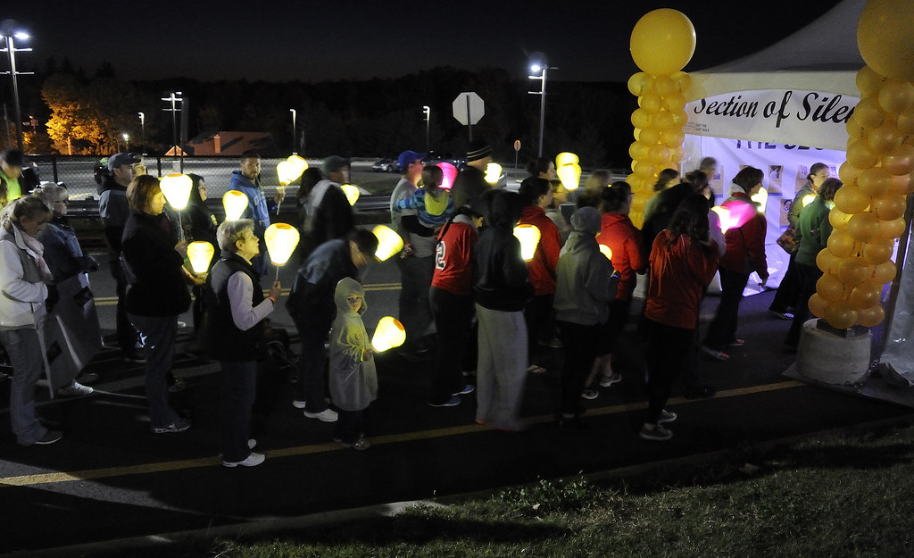 people in line with lanterns at light the night event