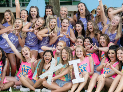 group of sorority girls holding up their greek letters