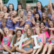 group of sorority girls holding up their greek letters