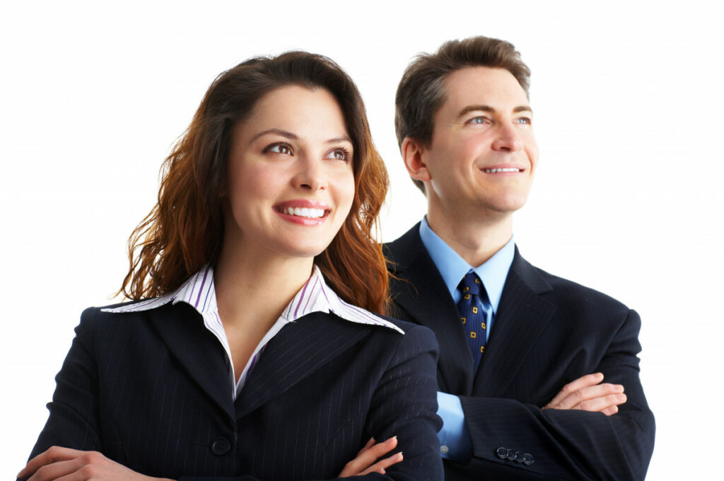 Photo of two business people smiling with confidence off into the distance