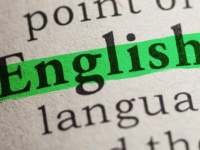 The word 'English' highlighted in green on a white paper.