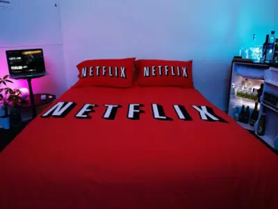 Bed with Netflix and chill sheets and pillows