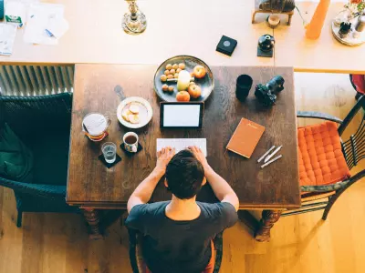 man writing at a table