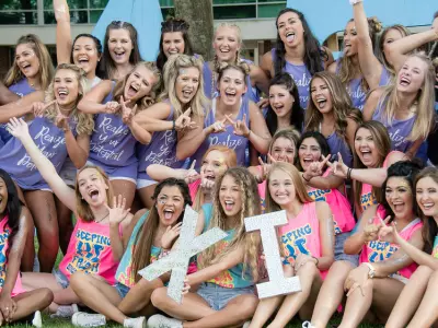 group of sorority girls holding up their greek letters